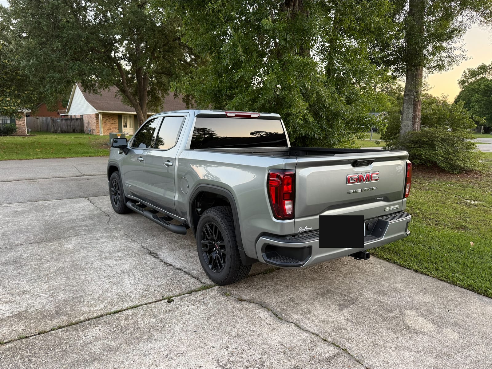 Silver GMC Sierra rear view with window tint
